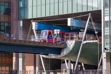 LONDON, UK - JANUARY 30, 2016: Docklands Light Railway or DLR train leaving Heron Quay station in...