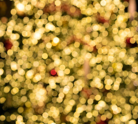 Defocused bokeh of christmas tree lights to be used as abstract background for holiday imageの写真素材