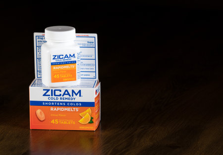 MORGANTOWN, WV - 4 JANUARY 2017: Zicam cold remedy homeopathic supplement and bottle on wooden tableのeditorial素材