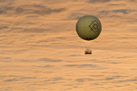 Balloon ride rising into the air in front of dramatic sunset at San Diego safari parkのeditorial素材