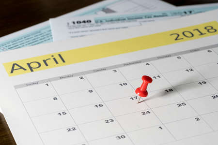 Calendar on top of form 1040 income tax form for 2017 showing tax day for filing is April 17 2018