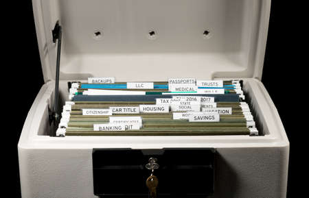 Close up of a well organized home filing system with tabs for each subject in fireproof safe
