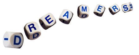 Dreamers children spelling letters on white background to illustrate dreaming of the futureの写真素材