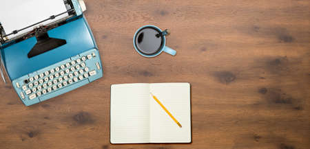 Modern electric typewriter on wooden desk background with copy space for hero headerの写真素材