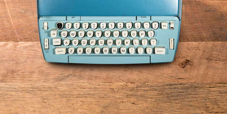 Modern electric typewriter on wooden desk background with copy space for hero headerの写真素材
