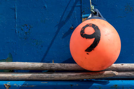 Blue fishing boat with orange bumper at Camara de Lobos on island of Madieraの写真素材