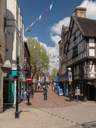 OSWESTRY, SHROPSHIRE, UK - MAY 15, 2018: Shoppers on Bailey Street in Oswestry Shropshire