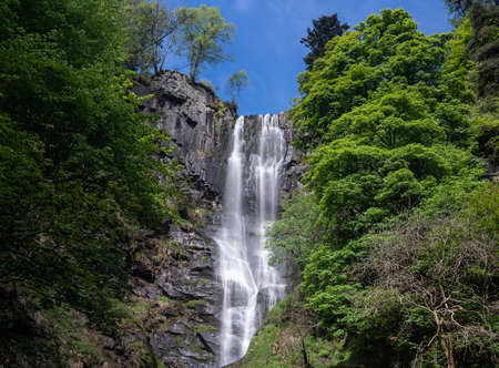 High falling water in waterfall and cascades at head of Pistyll Rhaeadr falls in Walesの写真素材