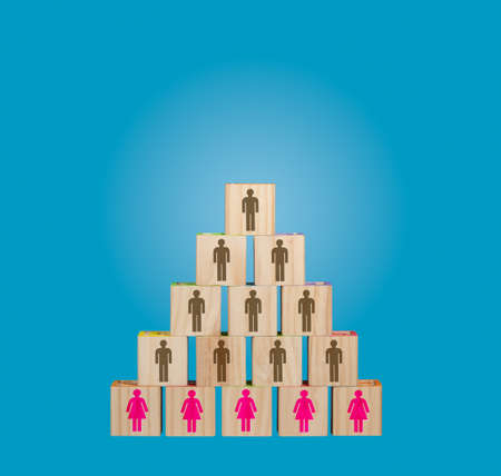 Concept image of traditional male dominated organization chart with women in menial roles made from blocksの写真素材