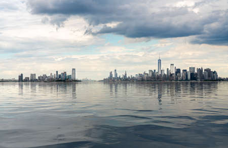Panorama of Manhattan in NYC and Jersey City with artificial water showing reflectionsの写真素材