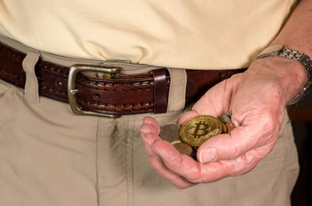 Concept of bitcoin or cyber currency only worth as much as loose change in mans hand