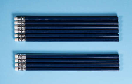 Row of new blue pencils lined up with erasers side by side. Copy space for back to school messageの写真素材