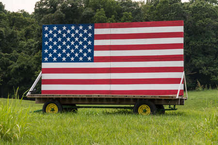 US flag painted onto a large billboard in a roadside field in Virginiaの写真素材