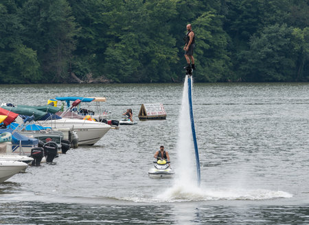 MORGANTOWN, WV - 11 AUGUST 2018: Man riding a FlyDive X Board hydroflight device on Cheat Lakeのeditorial素材
