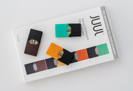 MORGANTOWN, WV - 25 AUGUST 2018: Juul e-cigarette or nicotine vapor dispenser box on and JUULpods on...