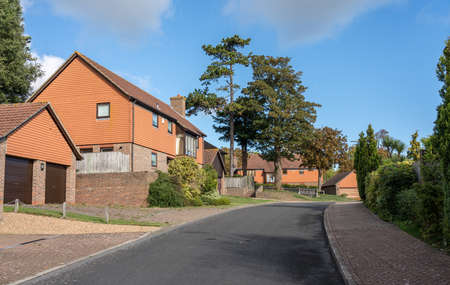 Street leading to a development of modern single family detached homes in the UK