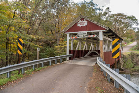 Narrow red painted Burkholder covered bridge near Garrett Pennsylvania