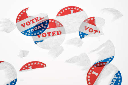 Torn and defaced I Voted Today stickers in aftermath of the US elections isolated on white backgroundの写真素材