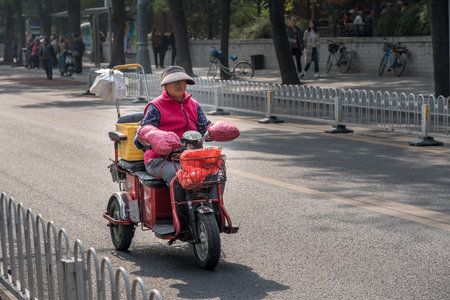 BEIJING, CHINA - 19 OCTOBER 2018: Electric vehicle with three wheels for street cleaner driving down roadのeditorial素材