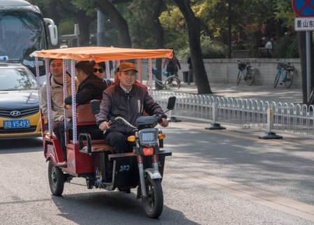 BEIJING, CHINA - 20 OCTOBER 2018: Electric three wheeler pedicab or taxi in Beijingのeditorial素材