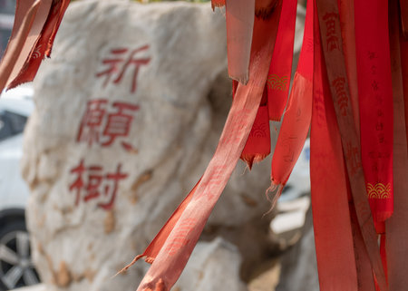 TIANJIN, CHINA - 22 OCTOBER 2018: Red prayer or wish ribbons by Yuhuang Pavilionのeditorial素材