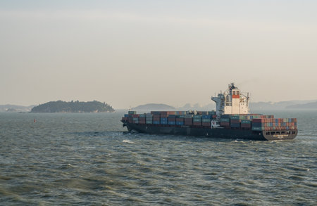 XIAMEN, CHINA - OCTOBER 30, 2018: Large container ship leaving port of Xiamen in China