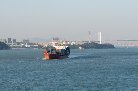 XIAMEN, CHINA - OCTOBER 30, 2018: Large container ship leaving port of Xiamen in China