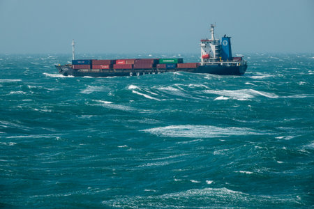SHANGHAI, CHINA - OCTOBER 30, 2018: Rough seas and waves batter the side of small container ship off the coastのeditorial素材