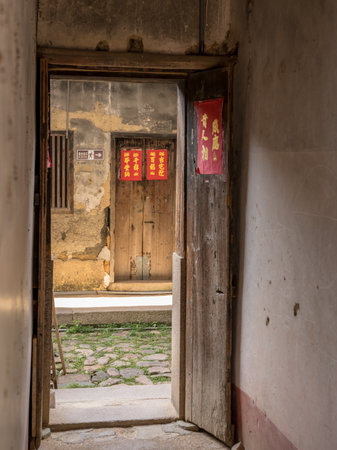 HUAAN, CHINA - OCTOBER 31, 2018: Wooden doorway at Tulou at Unesco heritage site near Xiamenのeditorial素材
