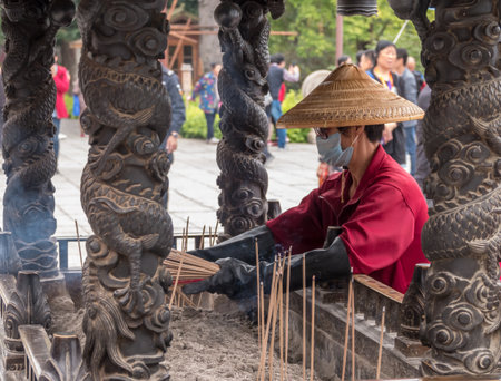 XIAMEN, CHINA - OCTOBER 31, 2018: Collecting incense sticks at South Putuo or Nanputuo Templeのeditorial素材