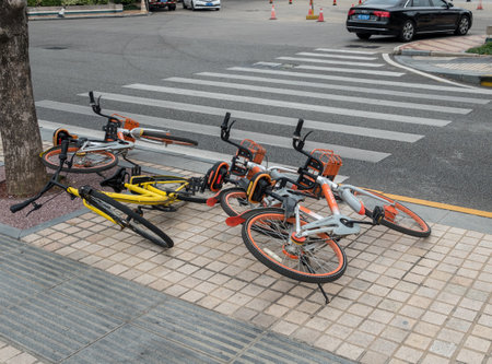 XIAMEN, CHINA - 31 OCTOBER 2018: Rental bikes abandoned by roadway