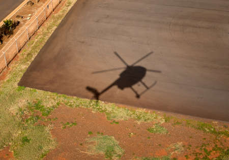 Shadow of small Hughes helicopter landing at Lihue in Kauaiの写真素材