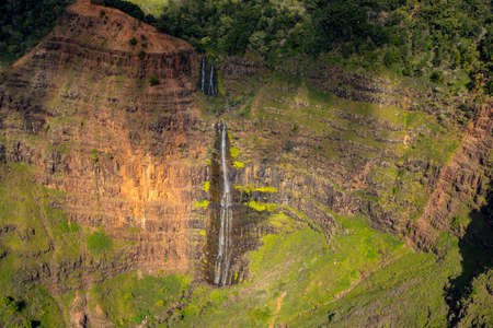 Aerial view of Waipoo waterfall and landscape of Waimea Canyon of Kauai from helicopter flightの写真素材