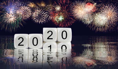 Composite of multiple firework explosions with calendar blocks showing 2019 sinking into the ocean...