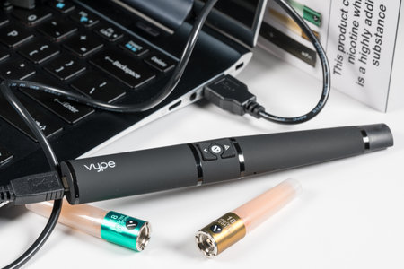 MORGANTOWN, WV - 6 MARCH 2019: Vype e-cigarette or ePen nicotine vapour kit being charged via USB on white backgroundのeditorial素材