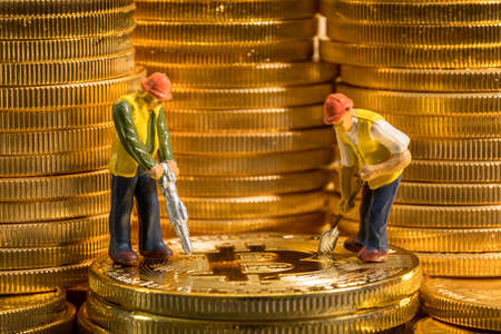 Concept illustration of two miners mining new bit-coin cybercurrency virtual coins in the blockchainの写真素材