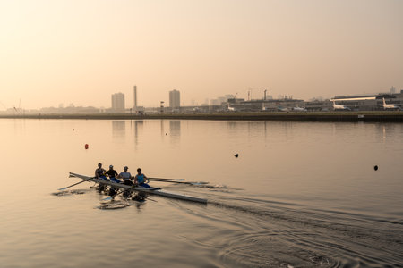 LONDON, UK - 17 APRIL 2019: Rowing team train by London City Airport on misty morning at sunriseのeditorial素材