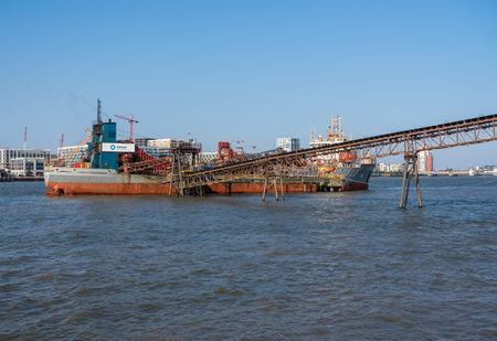 LONDON, UK - 21 APRIL 2019: Offloading of sand and aggregate gravel in Angerstein Wharf near Greenwich in Londonのeditorial素材