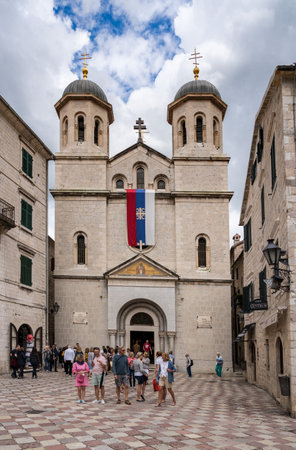 KOTOR, MONTENEGOR - 21 MAY 2019: Serbian flag flies on St Nicholas church in old town Kotor in Montenegroのeditorial素材