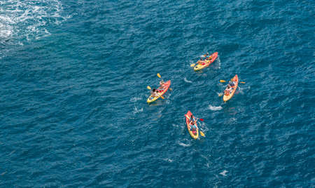 Kayakers or canoeists in the sea by the city walls in Dubrovnikの写真素材