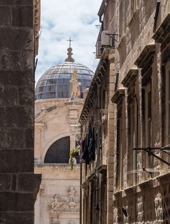 Statues and dome on St Blaise church in the old town of Dubrovnik in Croatiaの写真素材
