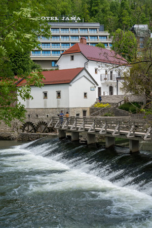 Postojna, Slovenia - 24 May 2019: Water wheel and hotel in the park by Postojnska Jama in Sloveniaのeditorial素材