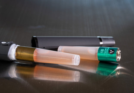 Morgantown, WV - 10 September 2019: Vype e-cigarette and nicotine vaping container on metal table