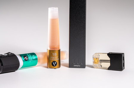 Morgantown, WV - 11 September 2019: Juul e-cigarette and nicotine pod with Vype ePen on white...