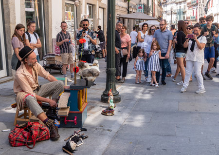 Porto, Portugal - 12 August 2019: Busker playing a card based music box or player piano in Oportoのeditorial素材