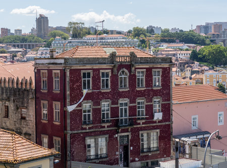 Porto, Portugal - 12 August 2019: Red or maroon ceramic tiles cover large house in downtown Oportoのeditorial素材