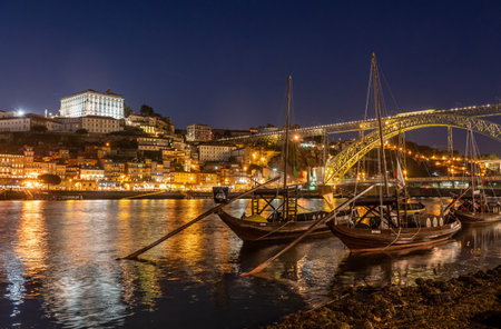 Porto, Portugal - 12 August 2019: Night view of rabelo boats and cityscape of Porto from the banks of the river Douroのeditorial素材