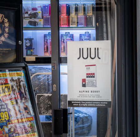 LONDON, UK - 4 October 2019: Large advert for Juul flavored nicotine on doorway to Vape store in Londonのeditorial素材