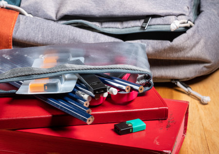 MORGANTOWN, WV - 12 October 2019: Juul e-cigarette or nicotine vapor stick and JUULpods in pencil case on school backpackのeditorial素材