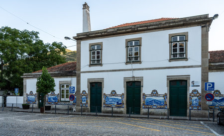 Pinhao, Portugal - 13 August 2019: Glazed tiles by J. Oliveira, depicting the Douro region and Port wine making activities.のeditorial素材